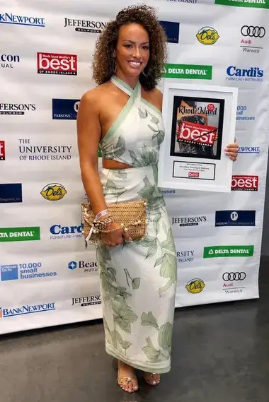 AfterGlow Tanning & Wellness owner holding the Rhode Island Monthly Best of Rhode Island 2026 Editors Pick award